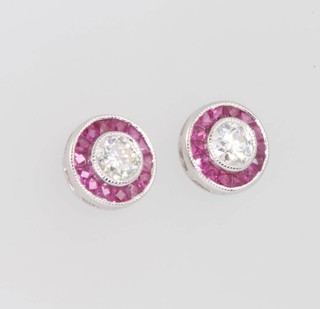 A pair of 18ct white gold diamond and ruby target earrings, the diamonds approx. 0.4ct, 8mm