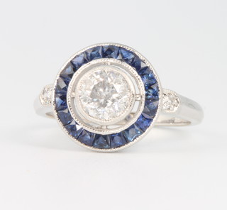 An 18ct white gold diamond and sapphire target ring, the centre stone approx. 0.86ct, size N 