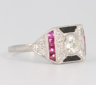 An 18ct white gold Art Deco style diamond, ruby and sapphire dress ring, the centre diamond approx. 0.6ct, size N 