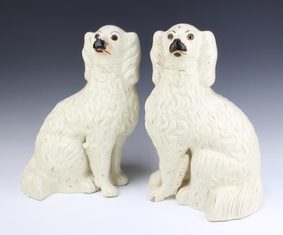 A large pair of Victorian Staffordshire fireside spaniels with separated front legs and gilt decoration with glass eyes 39cm 