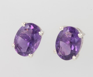 A pair of silver and amethyst ear studs 