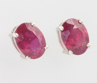 A pair of silver and ruby ear studs