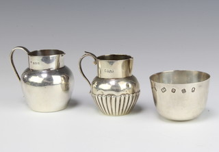 A silver tumble cup London 1977 and 2 cream jugs 230 grams