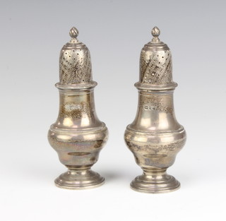 A pair of Edwardian silver pepperettes of vase form London 1900, 13cm, 176 grams 