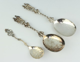 A pair of Victorian silver serving spoons London 1897 and 1898, a Rococo style ditto 157 grams 