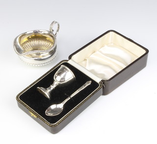 A silver cream jug of demi fluted pattern London 1913, together with a silver egg cup and plated spoon 