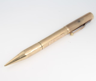 A 9ct yellow gold engine turned fountain pen and propelling pencil with 14ct Onoto nib