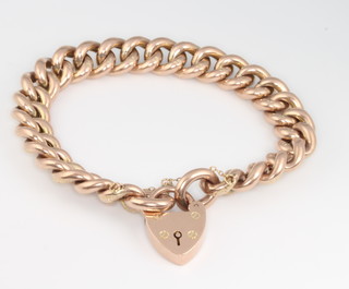 A 9ct yellow gold chased curb link bracelet and padlock 23.8 grams