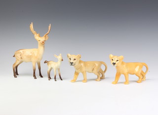 A Beswick figure of a lion cub facing left no.2098 by Graham Tongue 10.1cm, golden brown gloss, a ditto and 1 other of a stag standing no.981 by Arthur Greddington 20.3cm gloss and a faun 1000b with tail down by Arthur Greddington 8.9cm gloss 