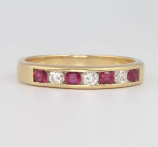 An 18ct yellow gold ruby and diamond half eternity ring, size X, 5.8 grams