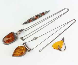 A pressed amber and silver pendant and chain, a ditto, another pendant and brooch 