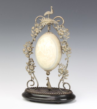 An engraved ostrich egg contained in a plated floral mount surmounted by an ostrich and with an ebonised base with kangaroo 30cm 