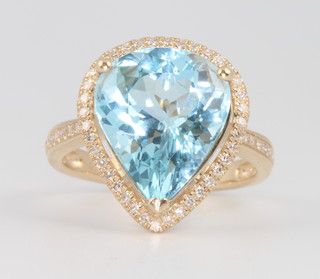 A 14ct yellow gold pear cut topaz and diamond ring and diamond ring, the centre stone approx. 7.48ct surrounded by brilliant cut diamonds approx. 0.45ct, size M 