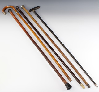 A walking cane with silver knop, a walking cane with gold band and 3 other walking sticks 