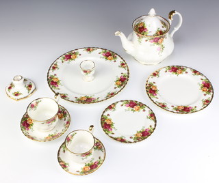 An extensive Royal Albert Old Country Roses table service comprising 4 napkin rings, 7 egg cups, 2 dishes (both seconds), 8 coffee cups (6 seconds), 1 milk jug, 1 cream jug, 1 small jug, 1 sugar bowl and lid, sugar bowl,  preserve pot, 1 sauce boat, a teapot, a coffee pot, an ashtray,  a cake plate, a small vase, (all seconds), 2 candlesticks, 2 knives, 1 cake slice, 8 tea cups (6 seconds), 8 tea saucers (6 seconds), 8 coffee saucers (5 seconds), 1 lid, 2 sandwich plates (1 second), 2 small dishes, 8 small bowls (6 seconds), 8 dessert bowls (all seconds), 2 serving bowls (both seconds), two oval meat plates (both seconds), 7 dinner plates (all seconds), 9 bowls (7 seconds and 1 chipped), 2 salad bowls (both seconds), 8 two handled bowls (6 seconds), 8 saucers (1 second), a 2 tier cake stand, 8 small plates (6 seconds), an ornament, a wall timepiece, a swan ornament, a wheelbarrow ornament, 8 small plates (6 seconds), a table bell, a small basket, 2 tureens (1 cracked and a second)  