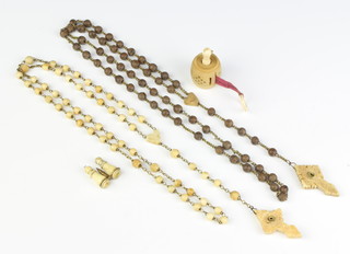 A carved bone tape measure, two stanhope rosaries and a miniature pair of Stanhope binoculars 