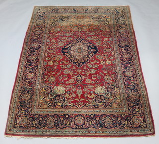 A red ground and floral patterned Kashan rug with central medallion and multi row border, 214cm x 125cm 