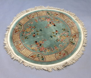 A Chinese circular green ground and floral patterned rug 134cm diam. 