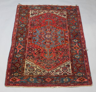 A red, blue and white ground Persian rug with 24 medallions within a multi row border 201cm x 132cm 