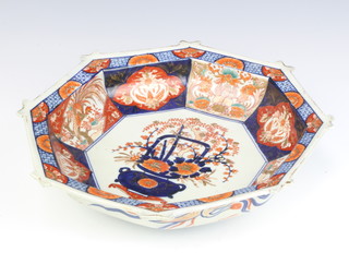 A 19th Century octagonal Imari bowl, the centre decorated with an urn of flowers enclosed by panels of stylised flowers and lions 35cm 