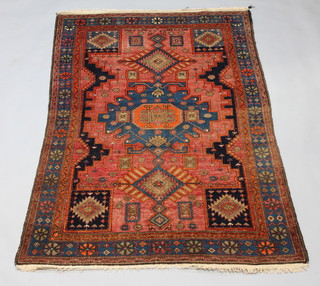 A tan and blue ground Persian carpet with 3 stylised medallions to the centre within a multi row border 193cm x 128cm 
