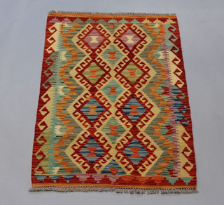 A brown, yellow and green Kilim rug 121cm x 82cm 