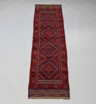 A red and blue ground Meshwani runner with 4 diamond medallions to the centre within a multi row border 236cm x 63cm 