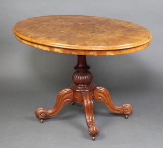 A Victorian oval figured walnut Loo table with quarter veneered top raised on a carved reeded column and triform base 72cm h x 107cm x 75cm 