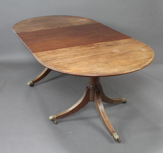 A Georgian style mahogany D end extending dining table with 1 extra leaf, raised on a twin pillar and base with brass caps and casters 73cm h x 106cm w x 137cm l x 208cm when extended