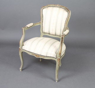 A green painted French style open armchair upholstered in striped material, raised on cabriole supports 