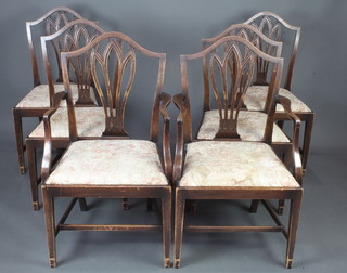 A set of 6 mahogany Hepplewhite style shield back dining chairs - 2 carvers and 4 standard with upholstered drop in seats, raised on square tapered supports