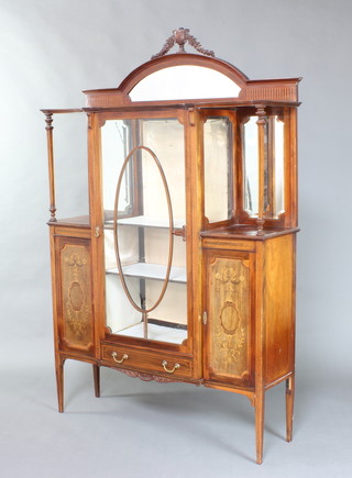 An Edwardian inlaid mahogany display cabinet with arch mirror panelled back, the centre section fitted shelves enclosed by astragal glazed doors with drawer to the base flanked by a pair of recesses with mirrored backs above 2 cupboards enclosed by panelled doors, raised on square tapered supports 206cm h x 130cm w x 37cm d 