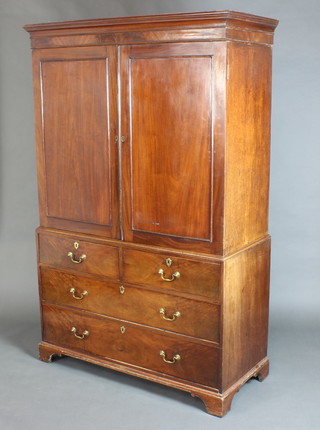 A Georgian mahogany linen press with moulded cornice, fitted 1 shelf enclosed by a pair of panelled doors above 2 short and 2 long drawers with replacement handles, raised on bracket feet 186cm h x 184cm w x 56cm d  