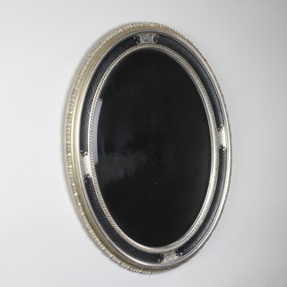 An oval Regency style plate mirror contained in a black and gilt frame 85cm h x 65cm w