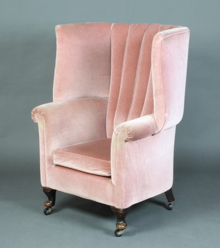 A Georgian style winged tub back chair upholstered in pink dralon, raised on cabriole supports 