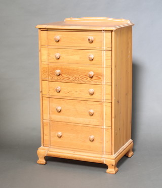 Younger, a pine pedestal chest of serpentine outline with raised back and 6 drawers, raised on ogee bracket feet 111cm h x 64cm w x 46cm d 
 