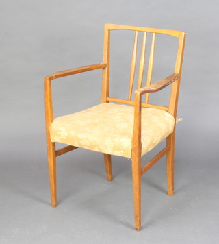 A pair of "Gordon Russell" teak stick and rail back carver chairs with over stuffed seats (1 arm F and R) 