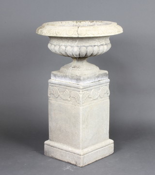 A well weathered circular garden urn raised on a square base with associated pedestal 97cm h x 58cm diam. (crack to the bowl of the urn) 