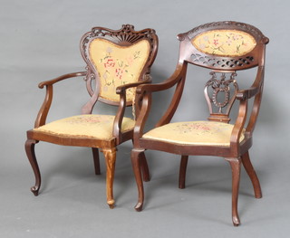 A pair of Edwardian pierced mahogany open arm chairs, upholstered in Berlin woolwork (1f) 
