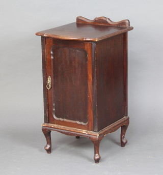 An Edwardian mahogany bow front bedside cabinet with raised back, enclosed by a panelled door, on cabriole supports 80cm h x44cm w x 45cm d 