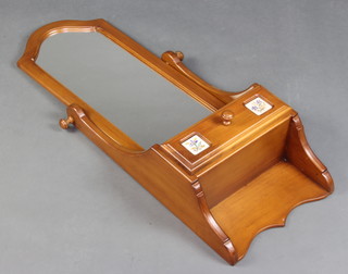 A Continental arched plate mirror contained in a "cherry" frame, the base fitted a drawer 99cm h x 35cm w x 18cm d