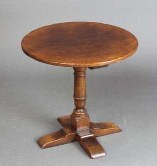 A circular oak pedestal occasional table raised on a turned column with cruciform base 47cm h x 50cm diam. 