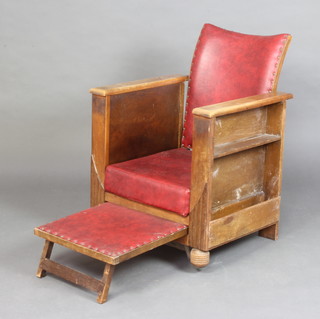 A 1930's oak and red rexine armchair, the base incorporating a foot rest 
