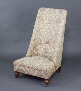 A Victorian nursing chair upholstered in floral patterned material 