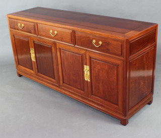 A Padauk sideboard fitted 3 drawers above triple cupboard enclosed by panelled doors 81cm h x 167cm w x 48cm d 