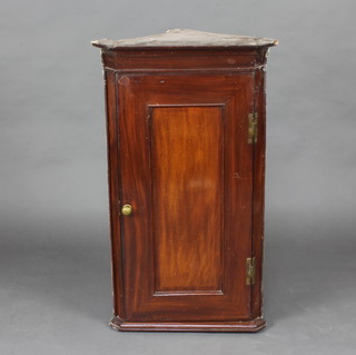 A 19th Century mahogany hanging corner cabinet with moulded cornice, the shelved interior enclosed by a panelled door 99cm h x 57cm w x 34cm d 