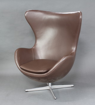 After Arne Jacobsen, an egg chair upholstered in brown leather 106cm h x 78cm w 