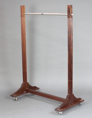 A mahogany and chrome clothes rail 153cm h x 117cm w x 67cm d  (missing finials to the top) 