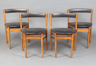 A set of 4 1960's teak and leatherette dining chairs, the seats of wedge form, on turned supports