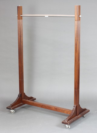 A mahogany and chrome clothes rail 153cm h x 117cm w x 67cm d